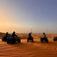 foto de clientes de 1001 Tours Morocco con quads al atardecer entre las dunas